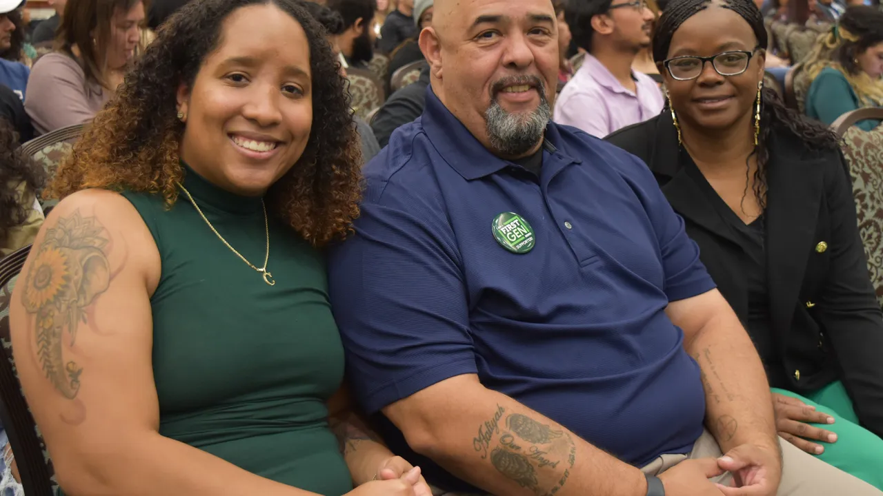First-Generation family sitting together smiling