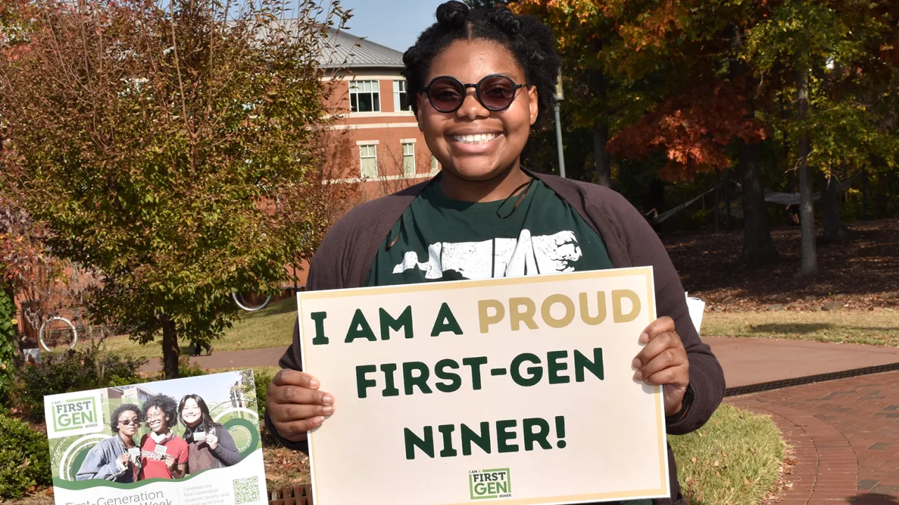 First-Gen student holding First-Gen Niner sign proudly
