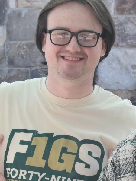 person wearing F1GS t-shirt smiling 