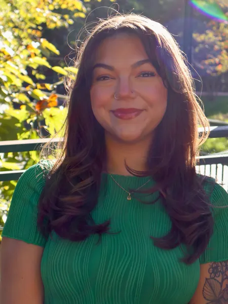 person wearing green smiling 
