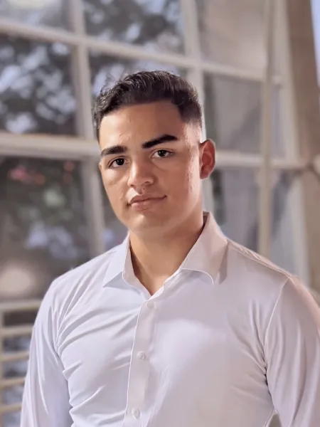 person in a white button up smiling