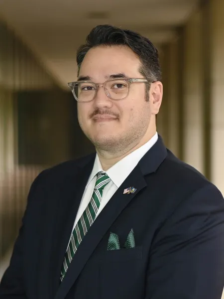 man with glasses and green tie