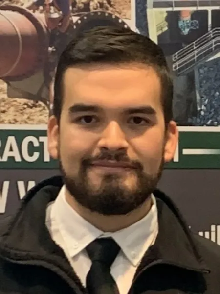 Person with a beard and black tie