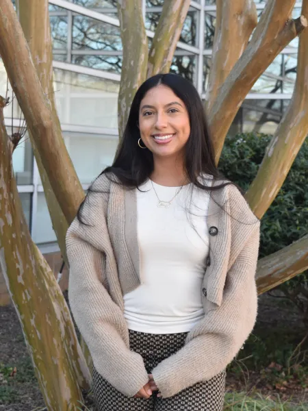 person standing in front of tree with beige cardigan
