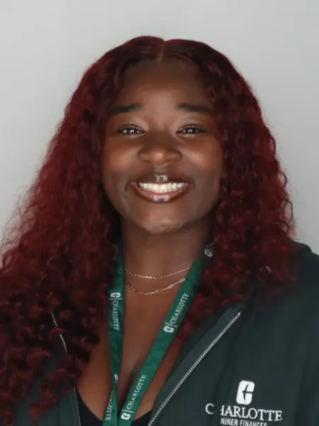 person in front of gray background smiling