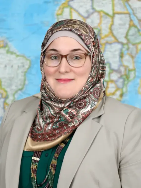 woman smiling with glasses and head scarf