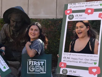 First-Gen Student with swag holding a photo frame smiling