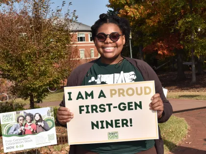 First-Gen student holding First-Gen Niner sign proudly